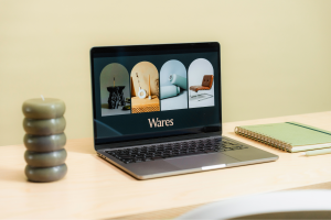 Laptop on a desk displaying modern product photography with the word "Wares," symbolizing a branding refresh.