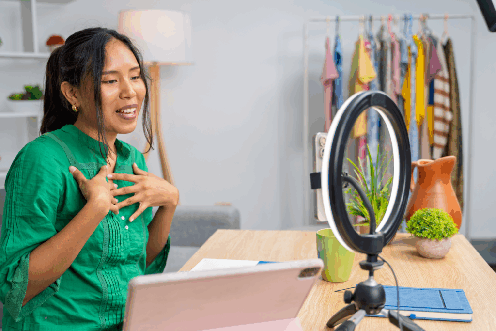 Social media influencer recording content with ring light for brand partnership collaboration