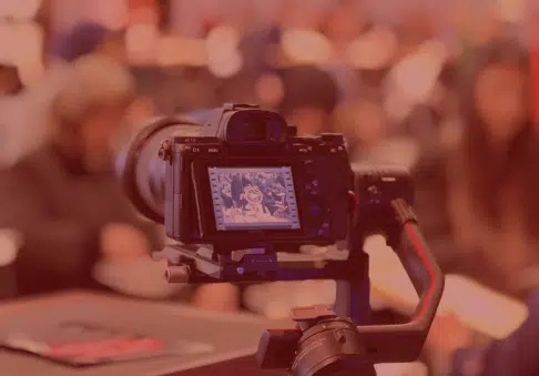A videographer filming on location